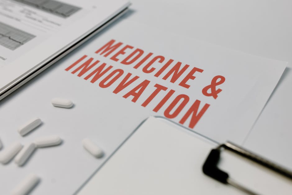 Close-up of 'Medicine & Innovation' paper with pills and documents on a desk.